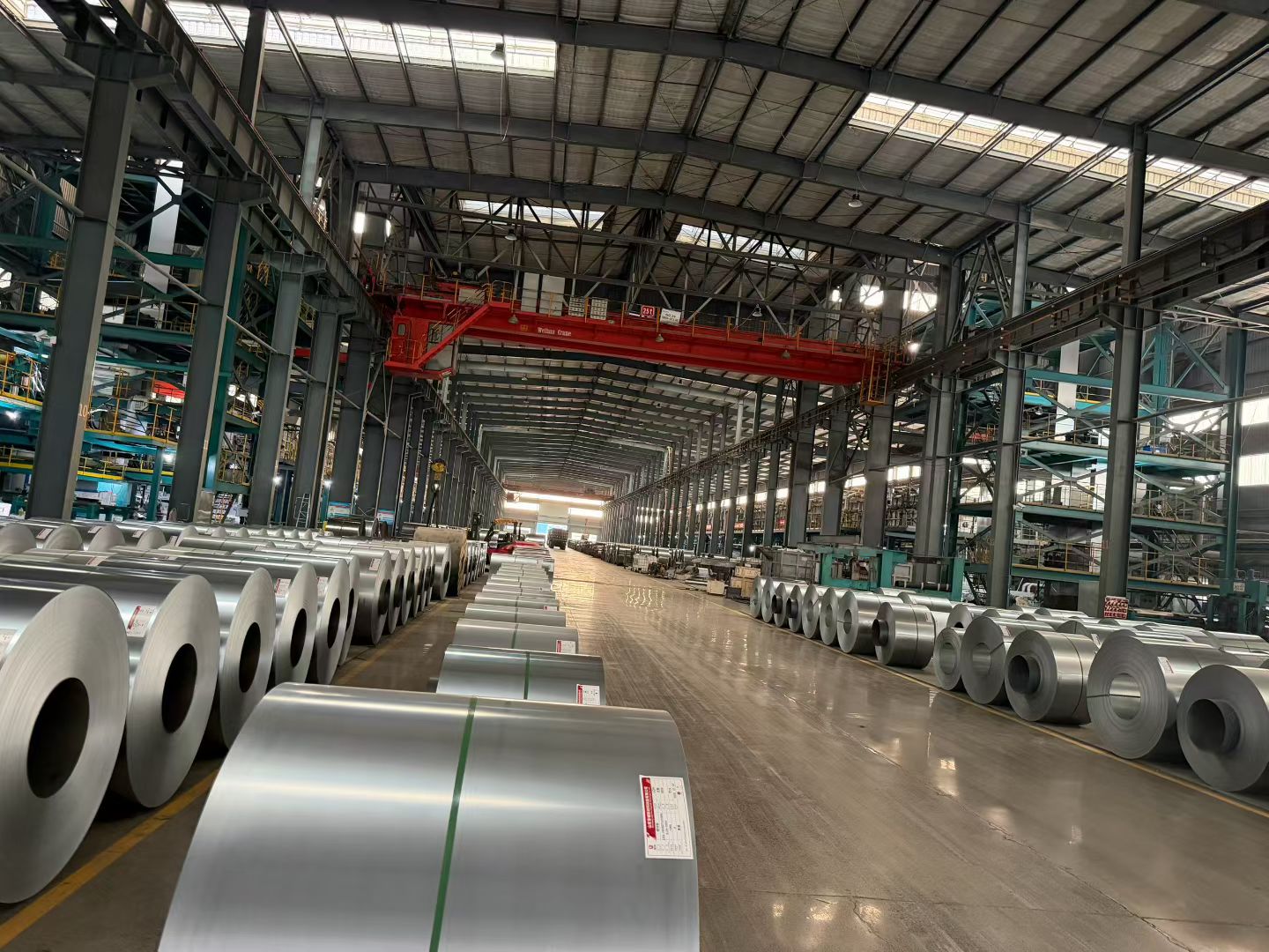 Steel coils and handling equipment in a warehouse